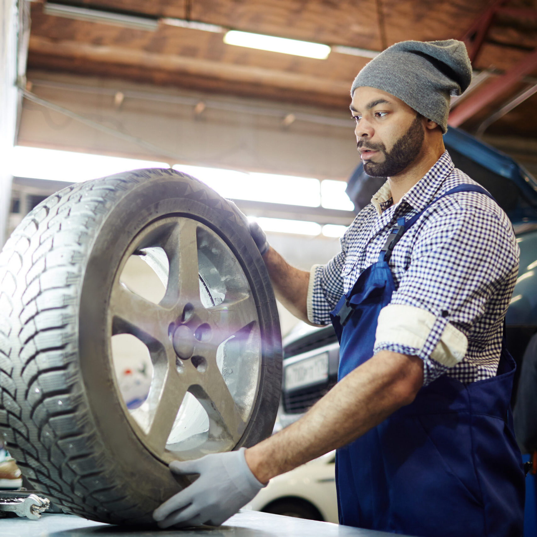 a man is mounting and balancing a tire
