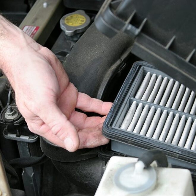 hand changing an air filter