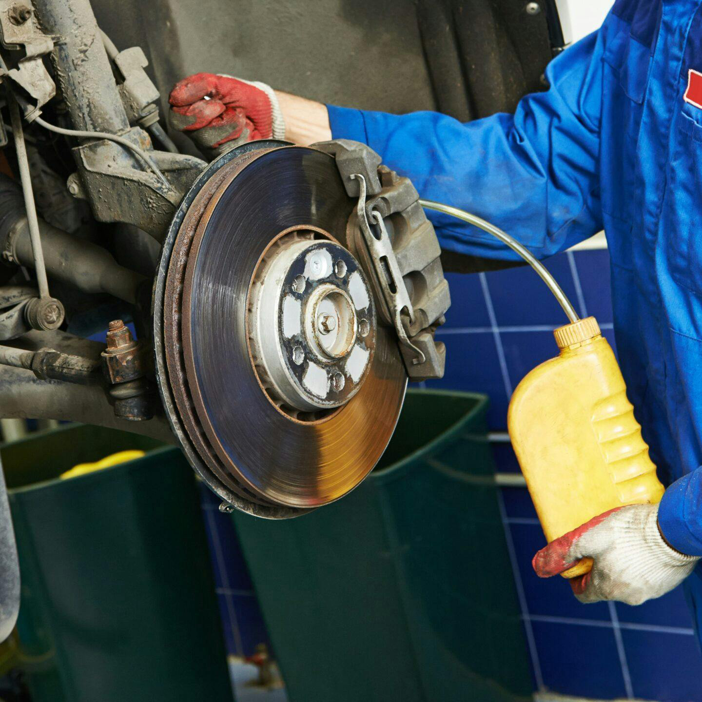 image showing a man replacing the brake fluid on a car