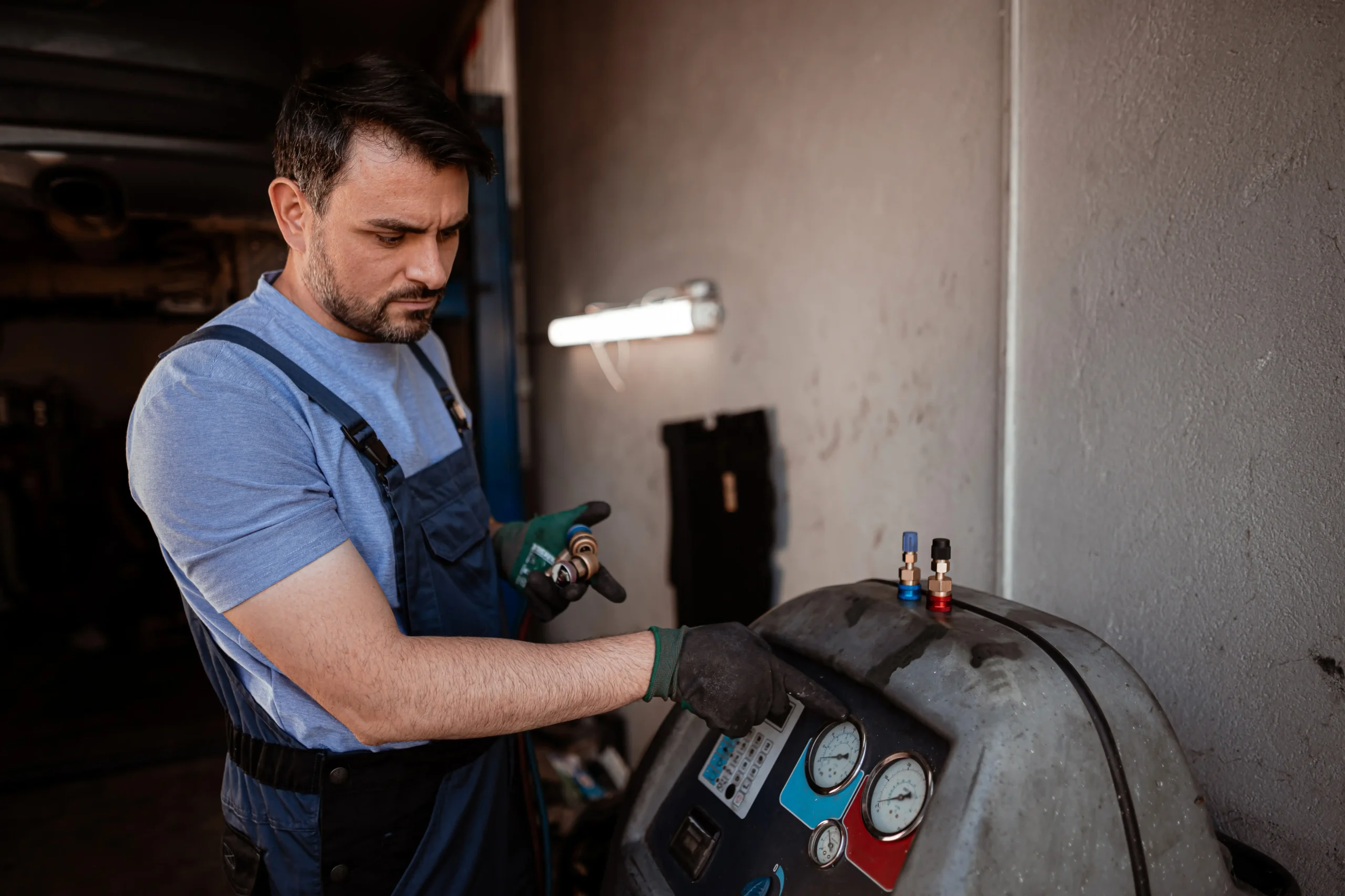 Technician inspecting a vehicle's air conditioning system to diagnose why the A/C is blowing warm air before recommending repairs.